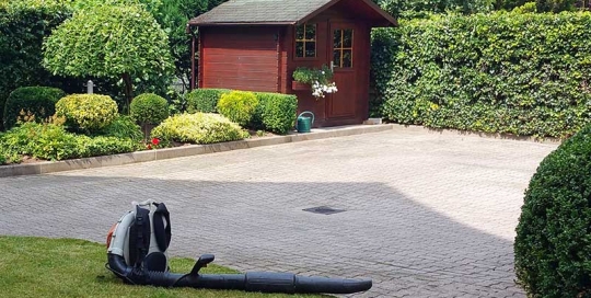 Garten mit Gartenhaus und Stihl Laubbläser nach Gartenpflegearbeiten in einem Hamburger Garten