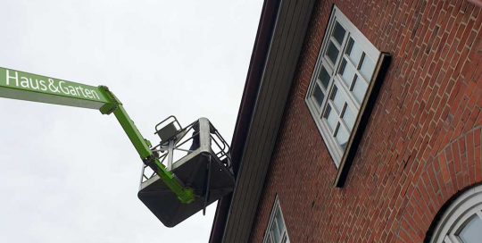 Regenrinnenreinigung mit LKW-Hubsteiger für schwer erreichbare Regenrinnen in Hamburg.